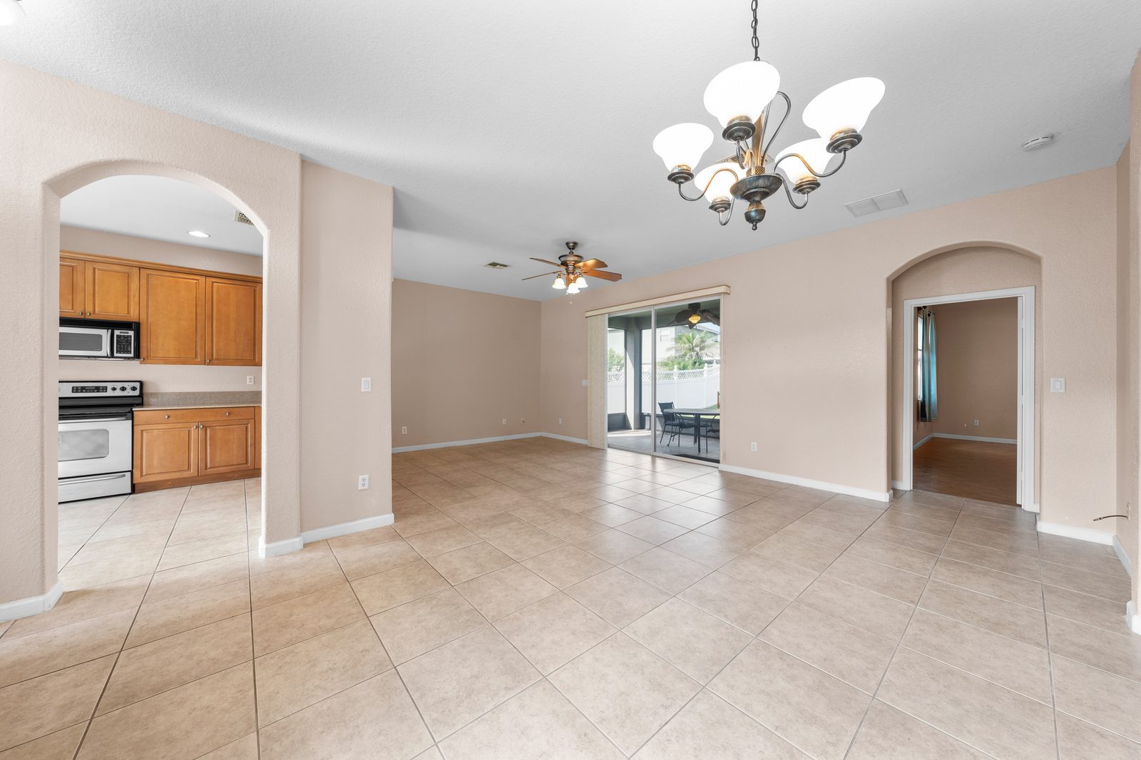 Kitchen open to the dining area with wood cabinets