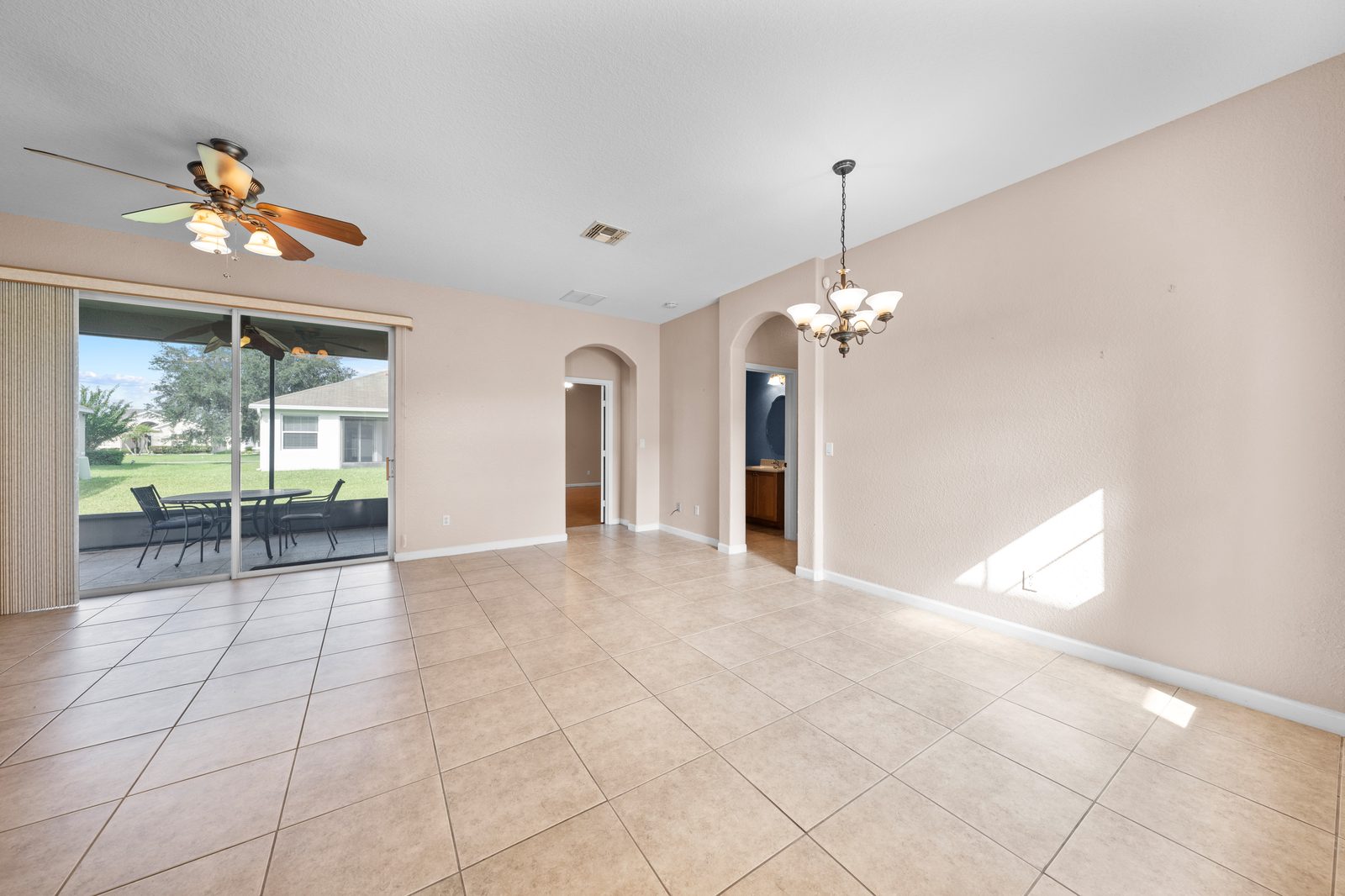 Living and dining area with sliding doors to the patio