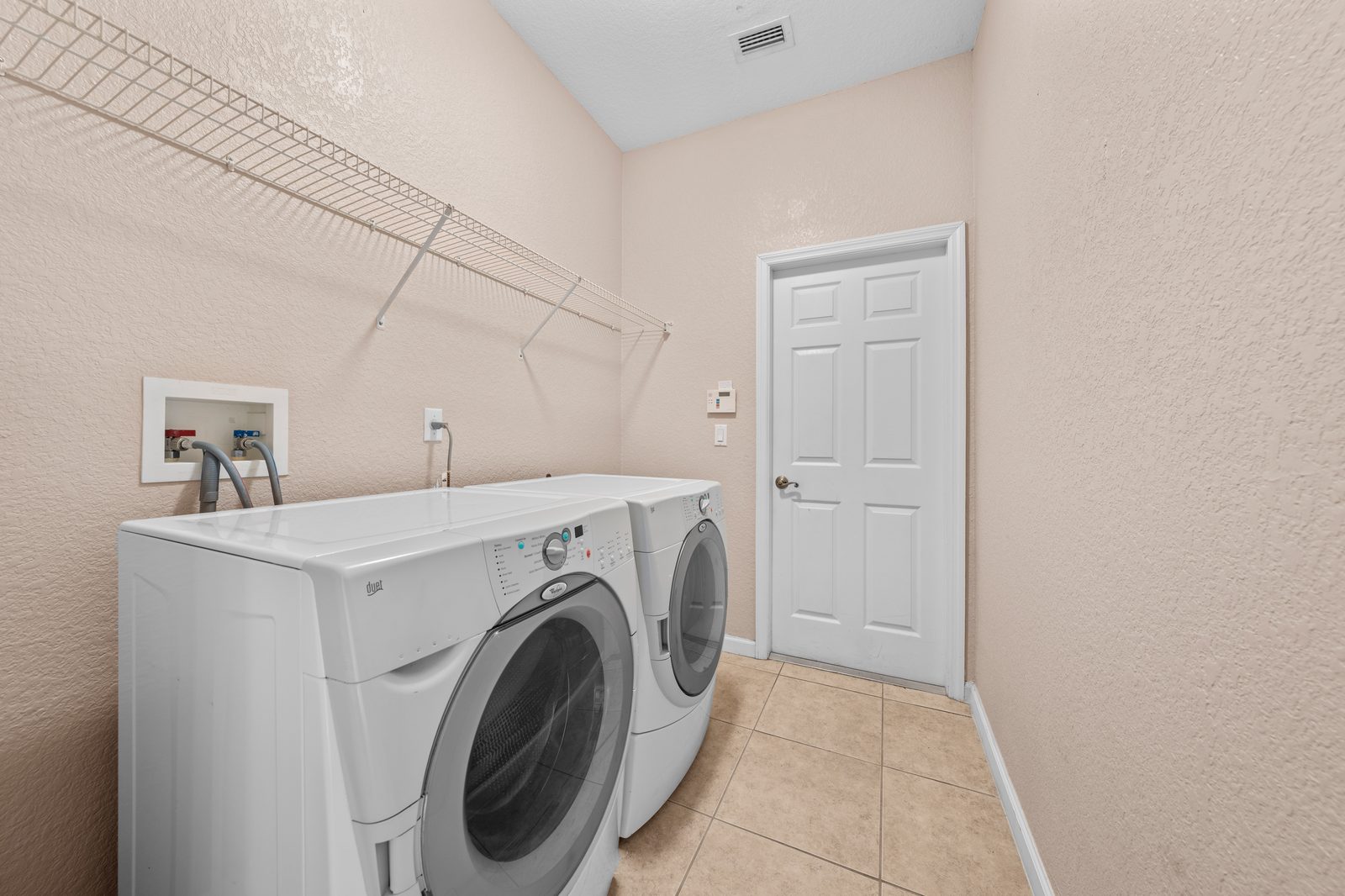 Indoor laundry room with garage access